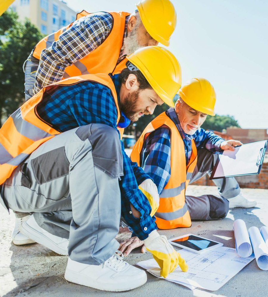handsome-construction-workers-sitting-on-concrete-at-construction-site-discussing-building-plans-1.jpg handsome-construction-workers-sitting-on-concrete-at-construction-site-discussing-building-plans-1.jpg